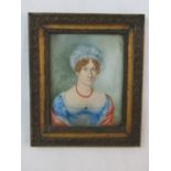 Early 19th century British school - Half length portrait of a lady in blue dress and coral necklace,