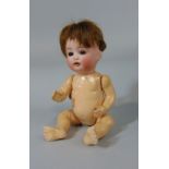 A bisque head doll, marked SP Germany, mould number 23 size 6/0, 21cm tall with teeth and sleeping