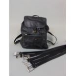 Black Fossil leather backpack with a collection of black men's belts including one by Hugo Boss