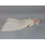 Schoenau & Hoffmeister closed mouth 'Dream Baby' doll in christening gown, 45cm tall