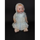 An Armand Marseille baby doll with bisque head, mould number 351, size 8k, 50cm tall approx