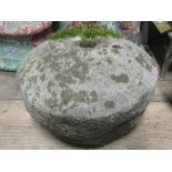 A weathered carved natural stone grind stone, 36 cm diameter approx