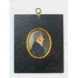 An early 19th century miniature portrait of oval form showing a bust length profile study of a