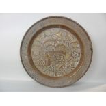 Interesting brass punch work charger engraved with an elephant amidst palm tree and foliage, 46cm