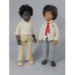 Two black Sasha boy dolls, with woolen jersey and in an RAF shirt and grey trousers