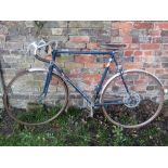 A vintage touring cycle, the tubular frame labelled Breizh, tan leather saddle, swept back