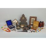 A box of interesting items to include a carved oak pocket watch stand, various beadwork items, a