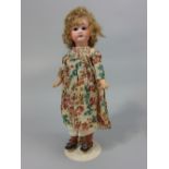 An Armand Marseille 1894 girl, with jointed body, raised on a later stand, 38cm approx