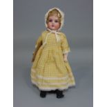 An Armand Marseille 370 mould bisque head doll, size 2/0, in later dress raised on a stand, 38cm