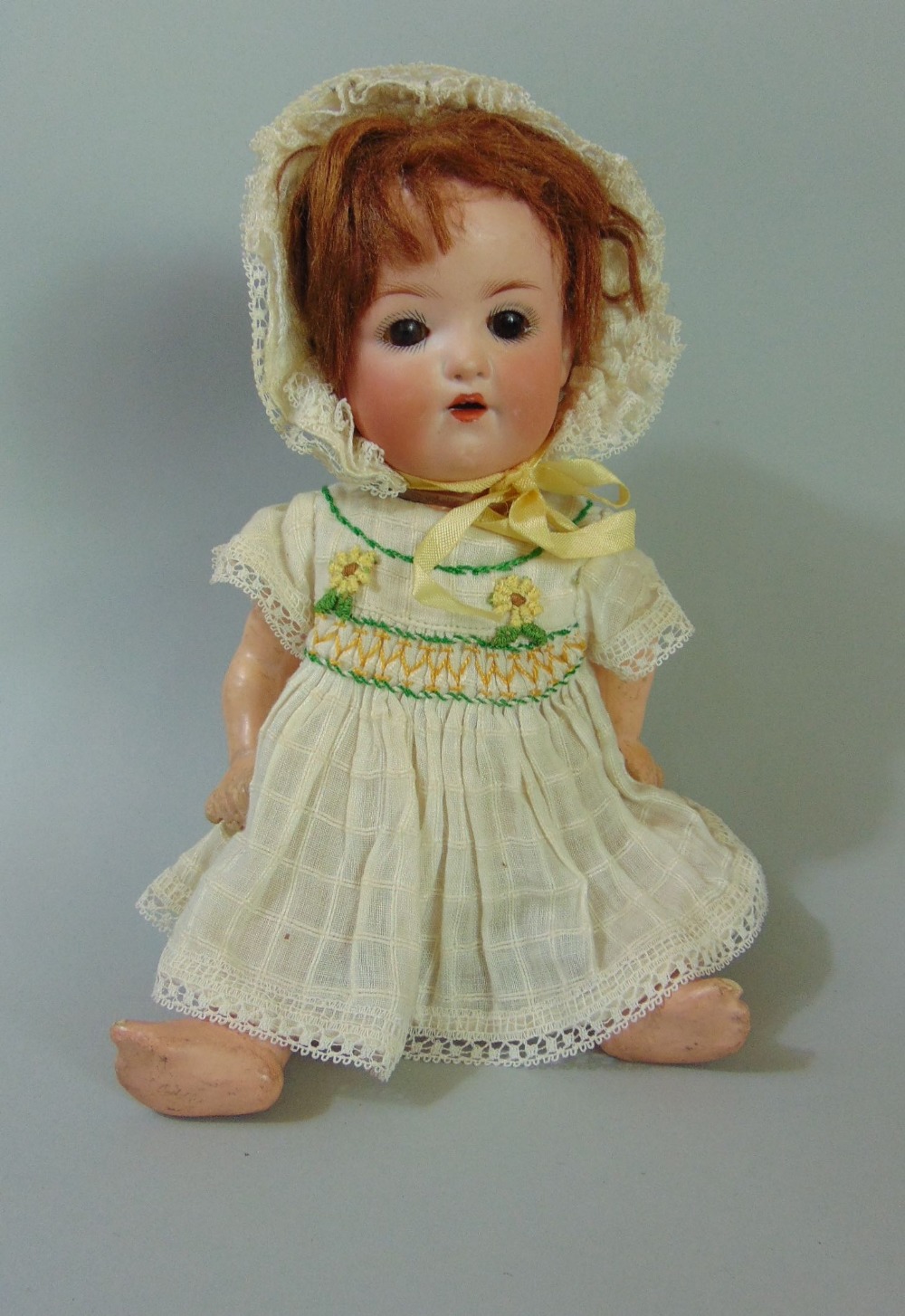 A small bisque head black headed doll by Armand Marseille, mould number 991, size 9 inches, with