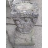 A weathered composition stone two sectional sundial in the medieval style, with figural and