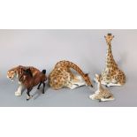 A group of three USSR models of giraffes comprising two recumbent adults and a recumbent baby, a