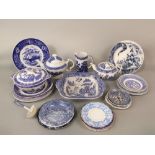 A quantity of blue and white printed wares, mainly Willow pattern examples including two tea pots,