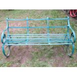 An old, probably 19th century, strap work three seat garden bench, with scrolled arms and sprung