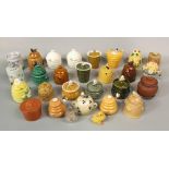 A collection of various ceramic honey pots including examples in the form of bee skeps, etc