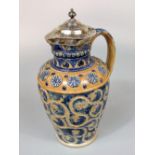 A 19th century stoneware ewer in the Doulton Lambeth manner with Arts and Crafts influenced