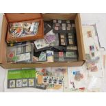 A box containing a collection of British and worldwide stamps in presentation cards and envelopes