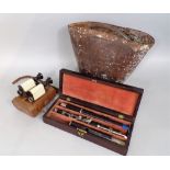 A rosewood cased flute, together with an antique leather fire bucket and cased set of binoculars (3)