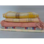 Four woollen woven blankets together with a vintage waffle bed cover