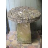 A weathered cast composition stone staddle stone with domed cap, approx 58 cm high, the cap 50 cm