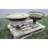 A weathered cast composition stone campana shaped garden urn, with lobed circular bowl and square