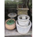 A weathered buff coloured composition stone planter of square form with Gothic tracery detail,