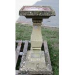 A weathered cast composition stone three sectional bird bath, with square stepped base and waisted