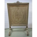 An Edwardian firescreen, the framework in the Adam style enclosing a hand worked tapestry panel with