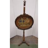 A Victorian rosewood pole/face screen with barley twist column supports and tripod base supporting a