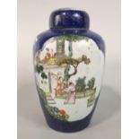 A 19th century oriental blue ground vase and cover of shouldered form with polychrome painted