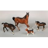 A collection of Beswick animals comprising a trotting brown horse, a shire foal and a further foal