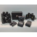 A box of seven mixed pairs of binoculars to include prismatic and compact examples