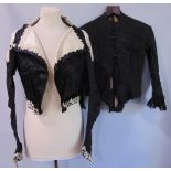 Victorian ladies black jacket with stayed bodice and ivory silk embellishments at the collar, hem,