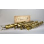 Four large brass music box cylinders, together with an antique instruction lithograph for changing
