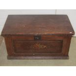 A 19th century scumbled pine box with hinged lid, iron fittings and painted floral detail