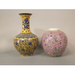 An oriental pink ground vase of globular form with polychrome floral decoration, 28cm tall, together