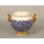 An early 20th century Coalport two handled pot and cover with blue and white printed floral