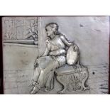 An early 20th century relief moulded silver plated plaque, decorated with a seated robed lady in