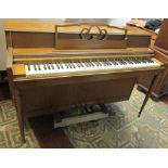 A Wurlitzer upright iron framed and over strung piano, model number 2109, serial number 1274377 with