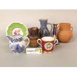 A collection of mainly 19th century ceramics including a puce ground cup with painted floral panel