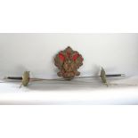A pair of fencing swords, together with a further carved Black Forest oak twin eagle plaque, (3)