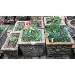 Six weathered cast composition stone garden planters including two pairs with simulated stone wall