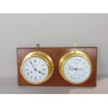 A brass twin bulk head type time piece by Greenoble of London, fitted with a twin train clock and