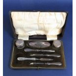 Leather cased manicure set to include two silver lidded jars, silver handled tools etc, the box 20cm