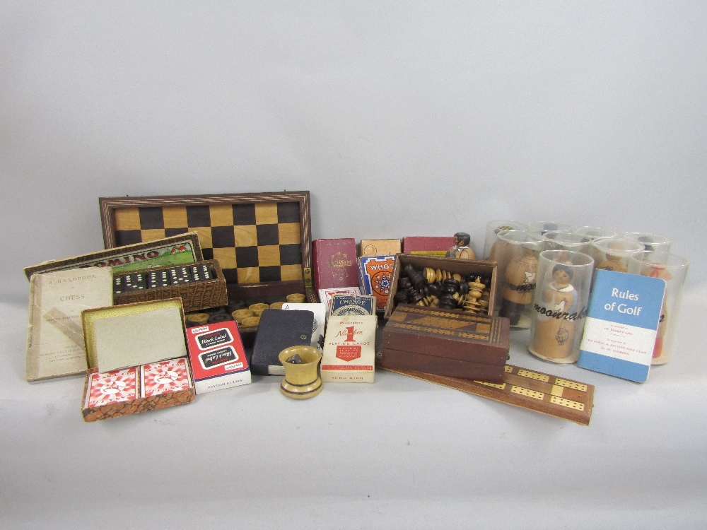 A 19th century mahogany travelling chess/droughts board containing a collection of draughts, further