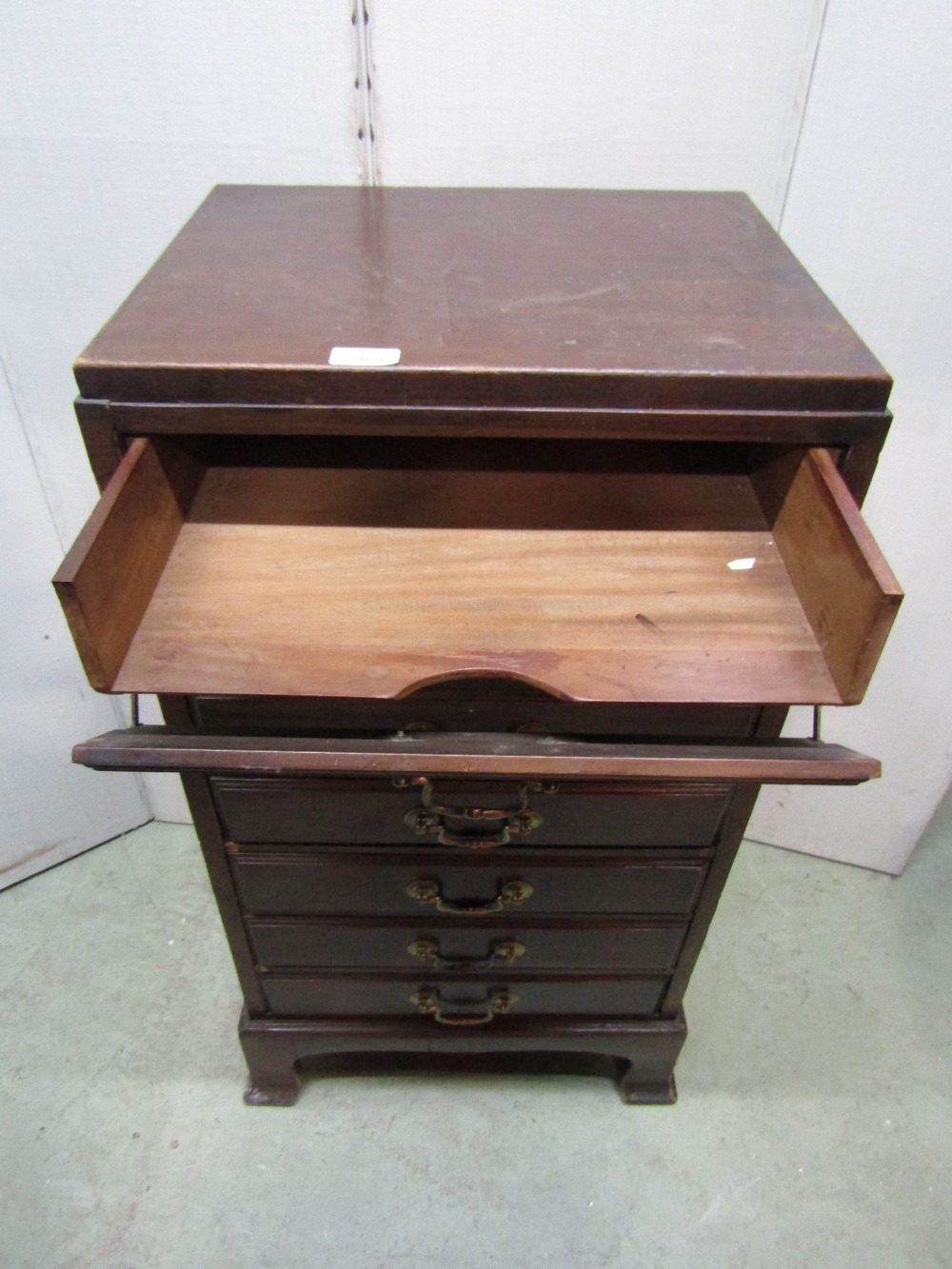 An Edwardian walnut sheet music cabinet fitted with a tower of seven drawers with fall fronts and - Image 2 of 2