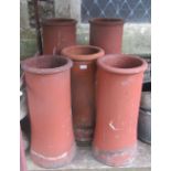 Five reclaimed terracotta chimney pots to include two pairs of circular slightly waisted form, the