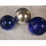 Three various witches balls, two in blue, the other in silver, the largest 17cm high