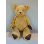Large teddy bear, 26" tall with jointed head and limbs, golden fur, glass eyes, stitched nose and