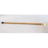 Malacca shafted walking cane with silver collar and ivory handle